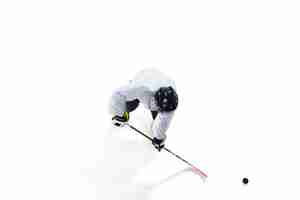 Free photo unrecognizable male hockey player with the stick on ice court