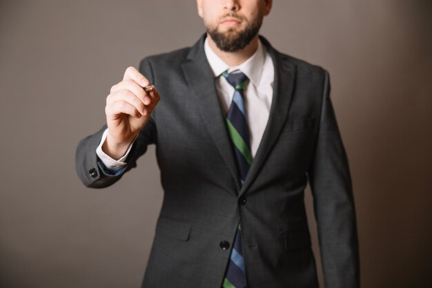 Unrecognizable man with pen in studio