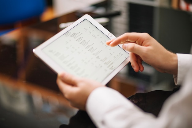 Unrecognizable man working with tablet