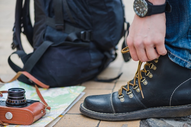 Free photo unrecognizable tourist tightening laces