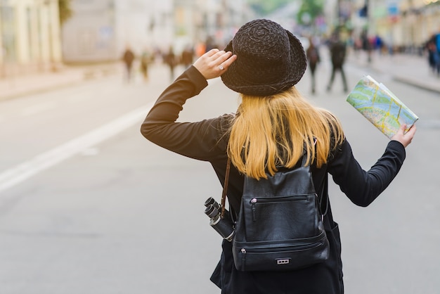 Unrecognizable tourist with map