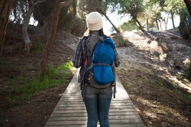 Unrecognizable woman on lumber path