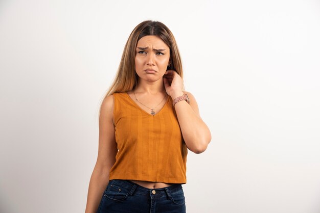 Upset woman posing on white background.