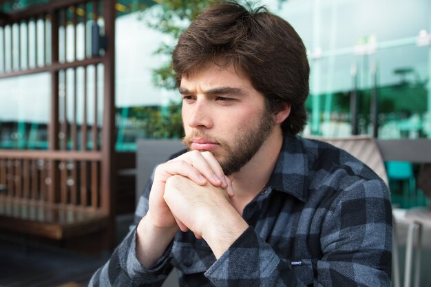 Upset young man thinking over bad news