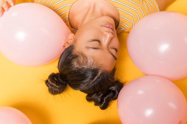 Free photo upside down woman surrounded by balloons