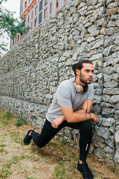 Urban athlete next to stone wall