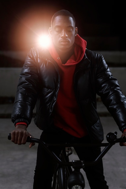 Urban cyclist sitting on the his bicycle in the night