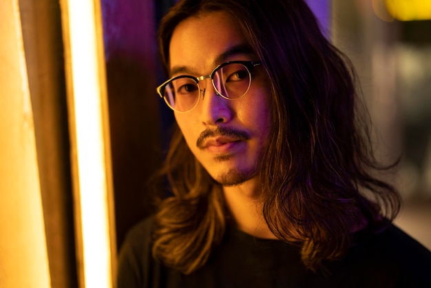 Urban portrait of young man with long hair