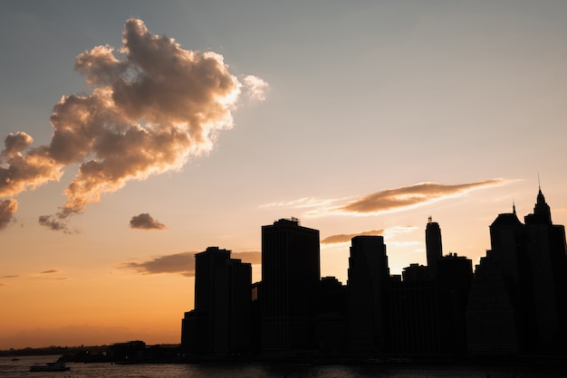 Free Photo urban skyline with skyscrapers at sunset