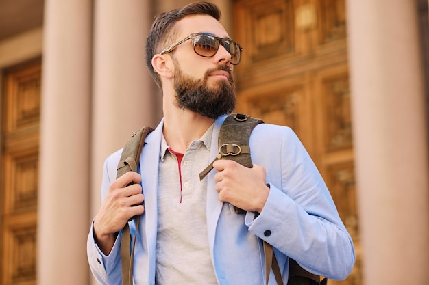 Urban traveller bearded man with a backpack.