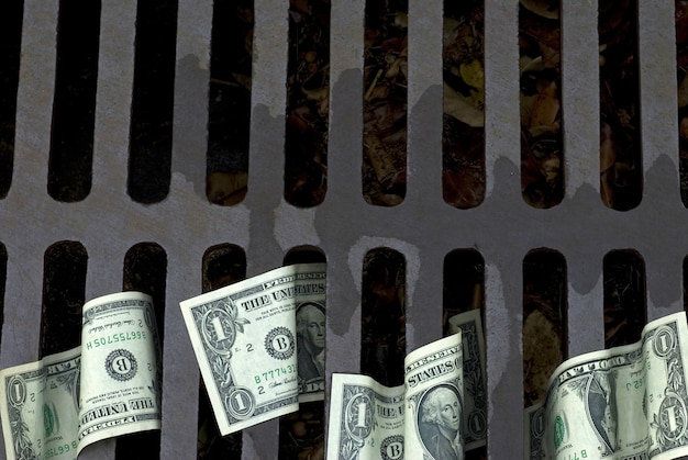 Free photo us dollar bills down the drain