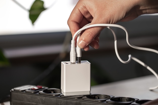 Free photo usb charging for gadgets on a blurred background of the room, close-up. the concept of technology in everyday life.