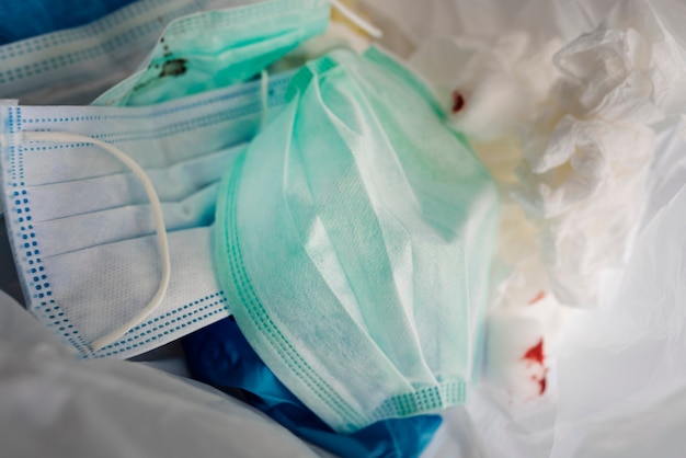 Free photo used face masks in a contaminated waste bin