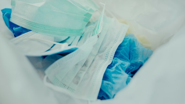 Used face masks in a contaminated waste bin