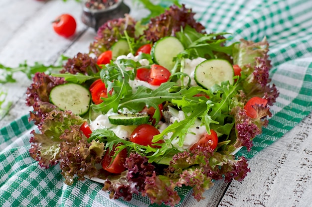 Useful dietary salad with cottage cheese, herbs and vegetables