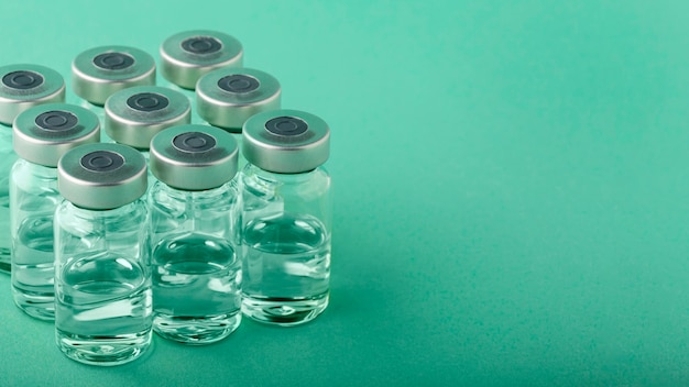 Vaccine bottle arrangement on green