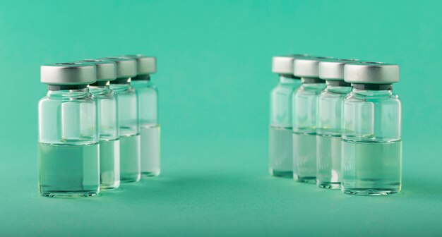 Vaccine bottle assortment on green