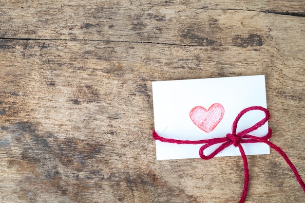 Free photo valentine card with hand drawn red heart and red rope