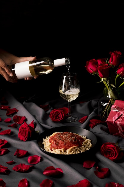 Valentine's day table set with wine and pasta