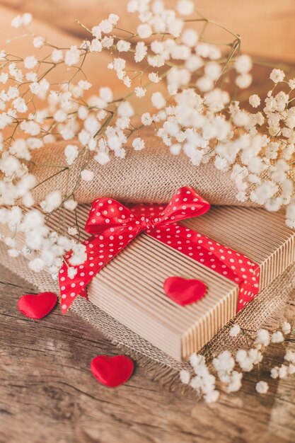 Valentine's gift on wood with red decorations