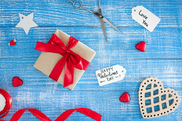 Free photo valentines day background with gift box on blue wooden background top view