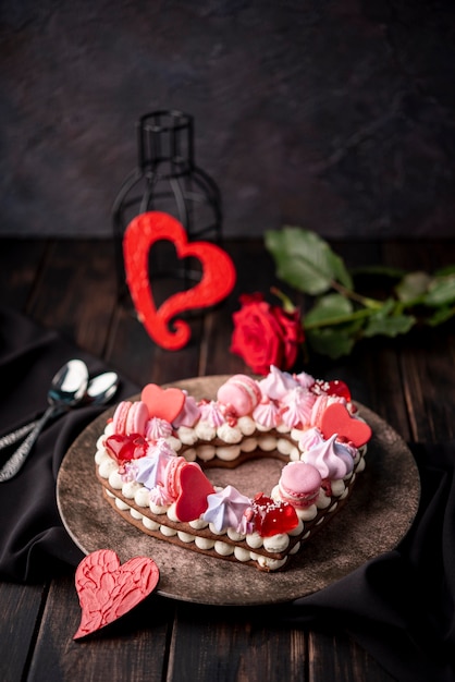 Valentines day heart-shaped cake with rose and spoons