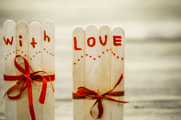 Valentines day love inscription on small wooden sticks with a heart