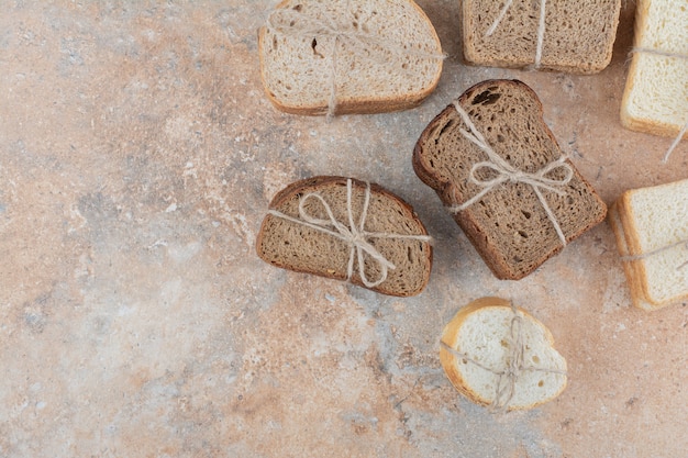 Variety of bread stacks on marble background