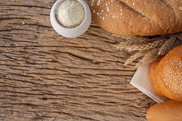 Variety of bread on wooden table on an old wooden background.