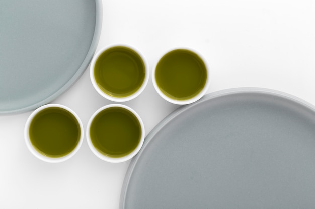 Free photo variety of ceramic cups with matcha tea