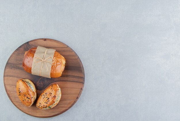 Free Photo variety of delicious pastries on wooden board. 