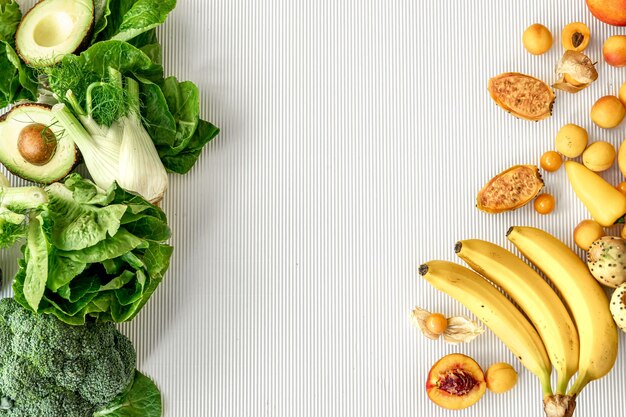 A variety of fresh vegetables and fruits on a white background flat lay