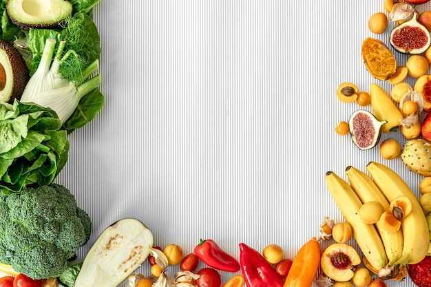 A variety of fresh vegetables and fruits on a white background flat lay