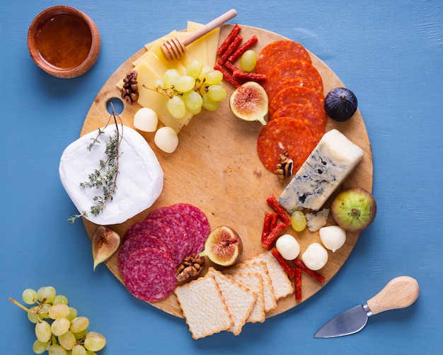 Variety of tasty snacks on a wooden board