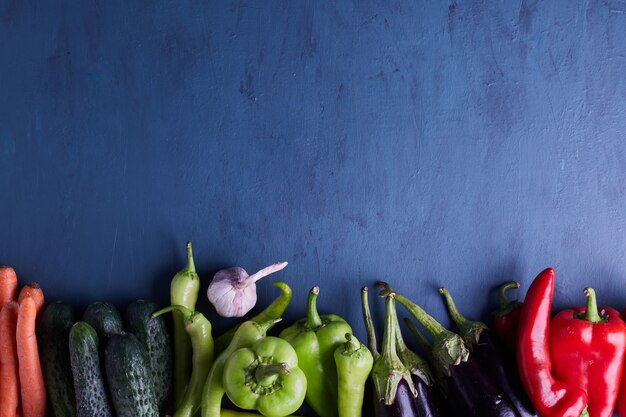 Variety of vegetables in the bottom of blue table.