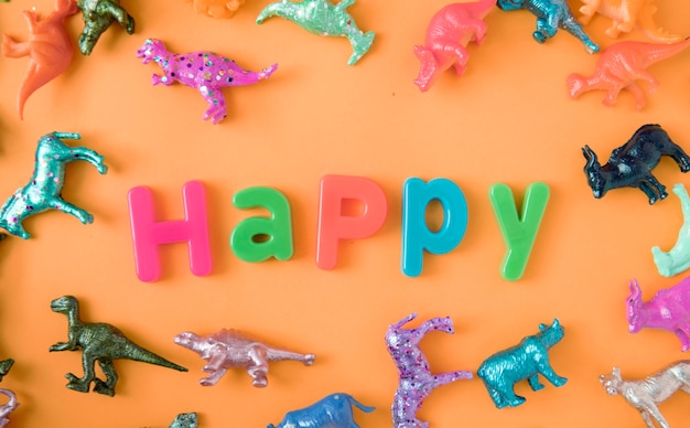 Free Photo various animal toy figures background with the word happy