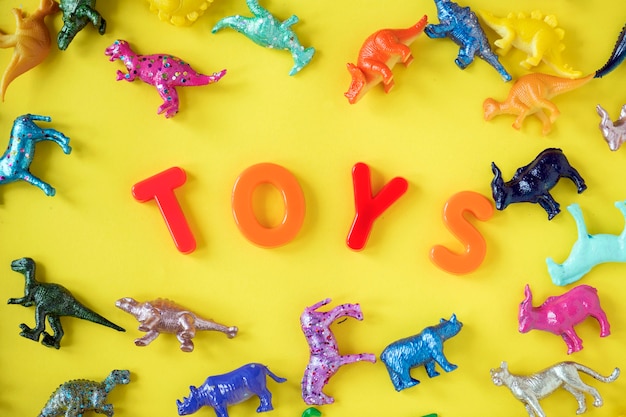 Various animal toy figures background with the word toys