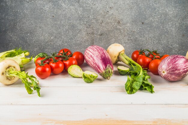 Various fresh vegetables arranged on wooden tabletop