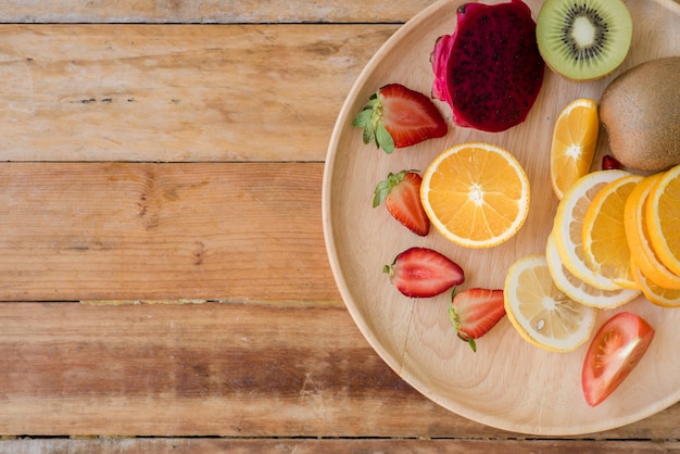 Various fruits with vegetable on wood background