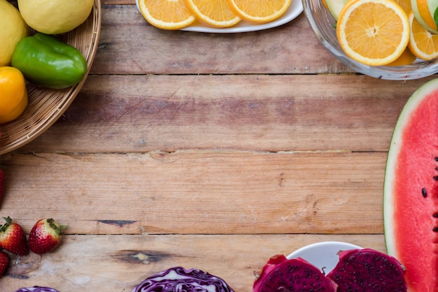 Various fruits with vegetable on wood background