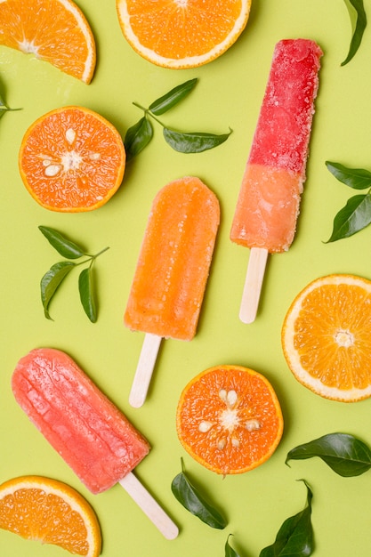 Various of ice cream flavour on stick with slices of orange