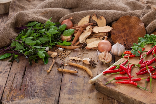 Various ingredients used to make Asian food are placed on a wooden table.