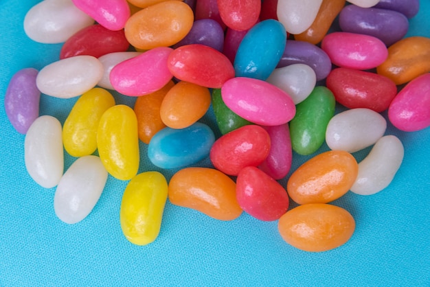 Various jelly beans on the blue background