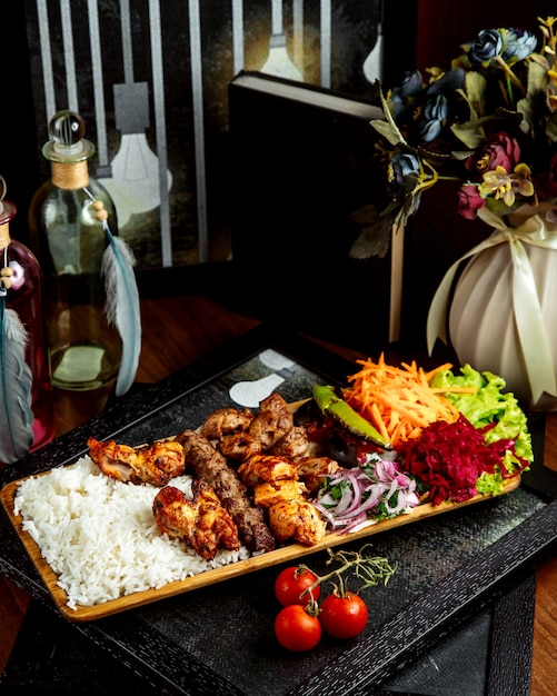 Various kebab with rice and vegetables