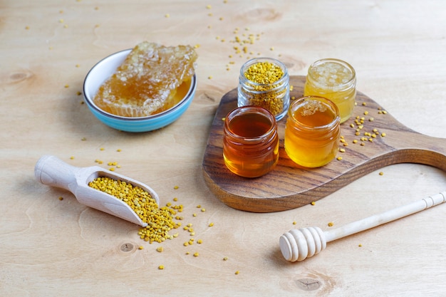 Free Photo various kinds of honey in glass jars,honeycomb and pollen