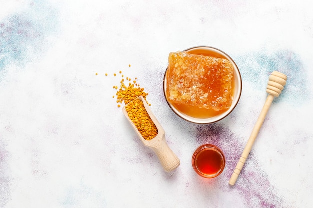 Free photo various kinds of honey in glass jars,honeycomb and pollen.