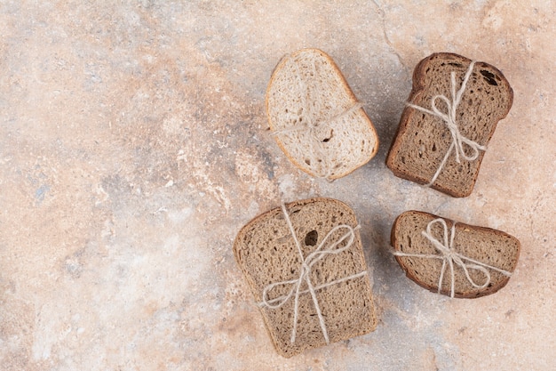 Free Photo various rye bread stacks on marble background