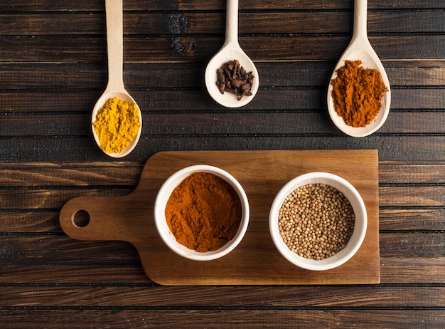 Free photo various spices near cutting board