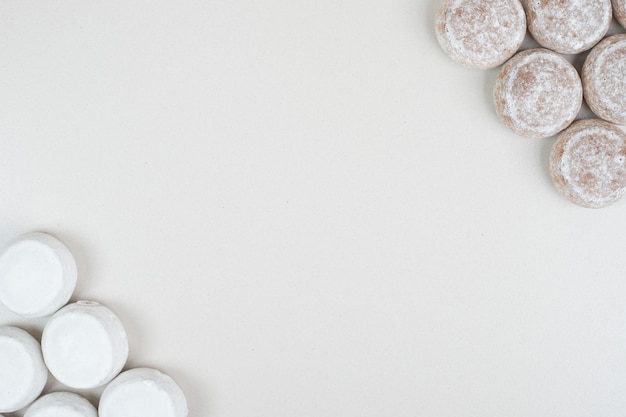 Various sweet cookies on beige surface