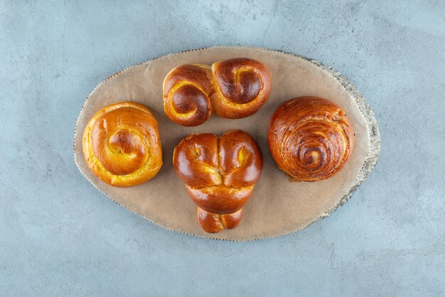 Various sweet pastries on wooden piece.